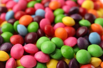 Many delicious colorful candies as background, closeup