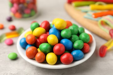Delicious colorful candies on light table, closeup