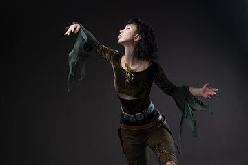 Young warrior elf with short dark hair, airy blouse and leather weapon belt