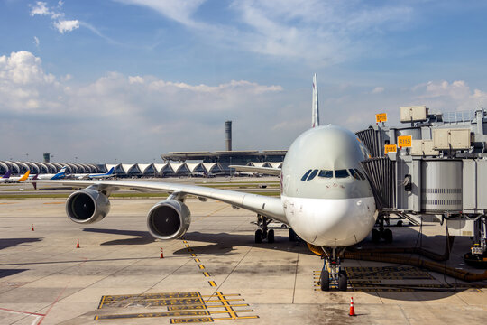 A double-decker plane parks next to a tunnel at International Airport