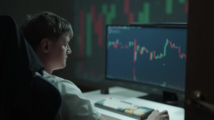 Happy excited young man monitoring financial market trends and investment opportunities, observing changing stock prices and trading graphs for strategic decision-making in digital finance at home. - Powered by Adobe