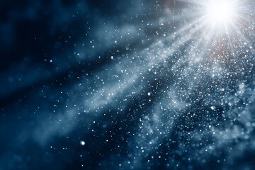 Fototapeta premium Blurred dark blue background with shiny glitter particles and sun rays, concept for Christmas, New Year and celebration