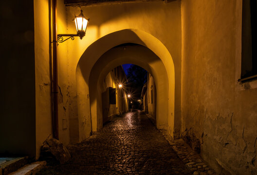 Narrow street with archway in medieval town Spisska Sobota at the night. Poprad city, Slovakia. Popular travel destination