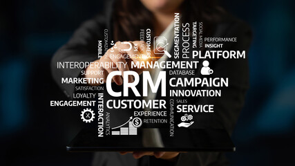 A professional showcases a tablet displaying key concepts of customer relationship management,...