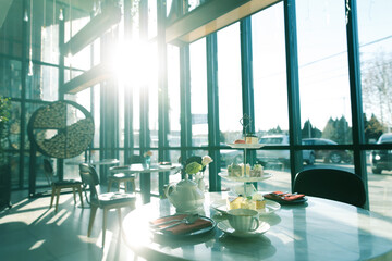Modern Restaurant Interior with Afternoon Tea Service and Large Windows