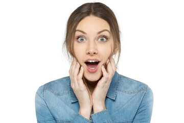 Fototapeta premium Portrait of a young woman in a denim shirt with wide eyes and open mouth, expressing surprise or shock
