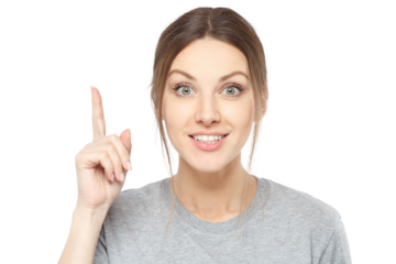 Smiling young woman in a grey t-shirt pointing her index finger up, showing a new idea or realization
