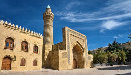 Obraz premium beige stone building featuring a tall cylindrical minaret baku azerbaijan