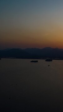 sunset hangzhou city famous lake boat ferry traffic aerial vertical timelapse panorama 4k china