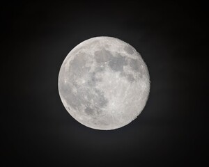 Detailed close-up of a waxing gibbous moon against a black night sky