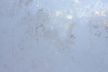 Snow and ice at frosty window outside.