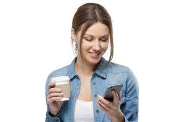Smiling young woman in a denim shirt holding a disposable coffee cup and using her smartphone