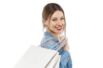 Attractive smiling woman in denim shirt with shopping bags over her shoulder