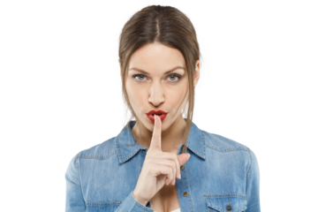 Serious woman asking for silence, holding a finger to her lips in a hush gesture