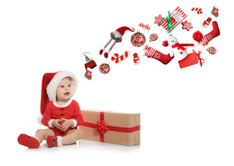 Cute little baby in Santa costume and flying festive stuff on white background. Christmas celebration