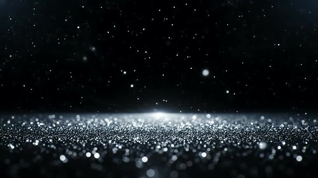 Shimmering silver glitter particles falling on a dark abstract background with sparkling lights
