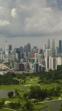 day time kuala lumpur city center golf course aerial vertical panorama 4k timelapse malaysia