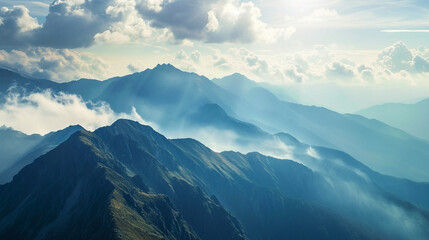 Majestic Mountainous Landscape with Clouds and Mist Covering Peaks and Valleys