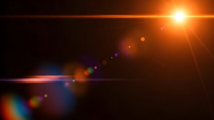 Bright orange light source creating a lens flare effect against a dark, starry sky background
