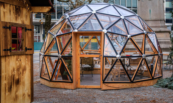 Cozy tables with fur throws in a Christmas igloo restaurant in Bern, Switzerland