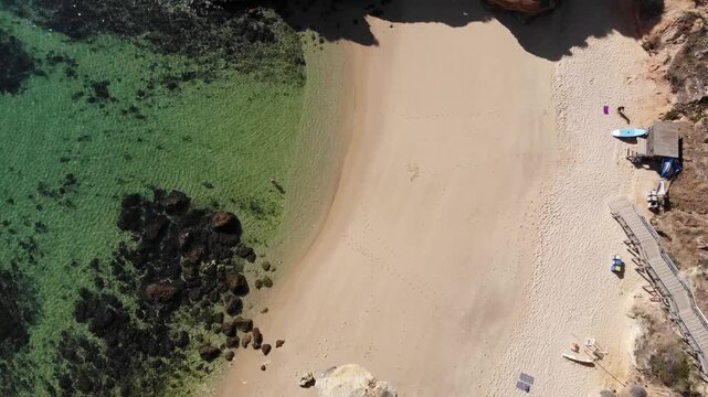 Camilo beach in Lagos Aerial Top Down View of Boardwalk Leading to a Pristine Sandy Beach and Clear Turquoise Ocean Water, Coastal Landscape and Summer Vacation Scene