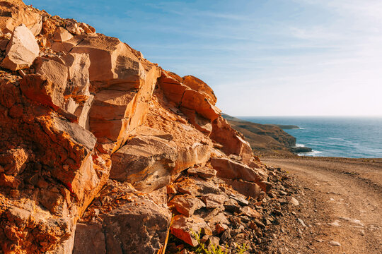 Mars-like volcanic rocky landscape on Fuerteventura, Canary Islands, barren stone terrain, mineral textures and arid wilderness under clear blue sky