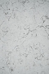 Rough white concrete surface with visible cracks and subtle texture, isolated and evenly lit. Suitable for backgrounds, design projects, or architectural presentations.
