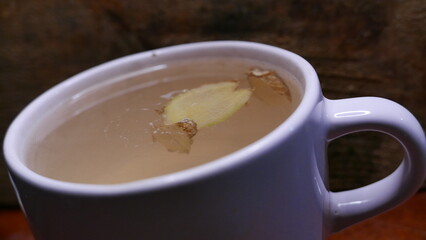 A ginger tea cup on the table. A cup of hot tea. A large cup of ginger tea. A tea mug, close-up shot.