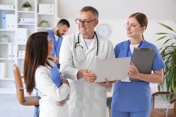 Fototapeta premium Team of doctors working with laptop in clinic