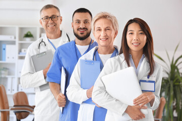 Team of doctors with laptops and clipboards in clinic