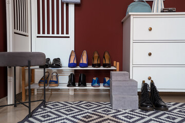 Interior of hallway with shoe stand, stool and folding screen