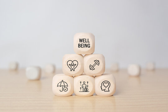 Employee wellbeing concept. Wooden blocks with physical, mental, emotional health icons. Creating employee benefits, satisfaction programs. Fostering positive work culture, employee engagement