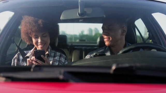 Man driving car, drinking coffee, woman typing on the smartphone. Slow motion