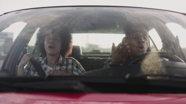 Male driver stopping abruptly on the road, woman scared. Slow motion