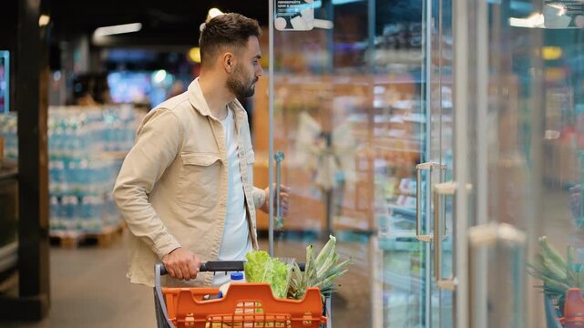 Man shopping for groceries and buying eggs in a supermarket