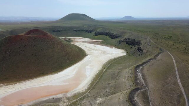 Drone aerial view of Lake Meke drying volcanic crater lake with red landscape in Turkey