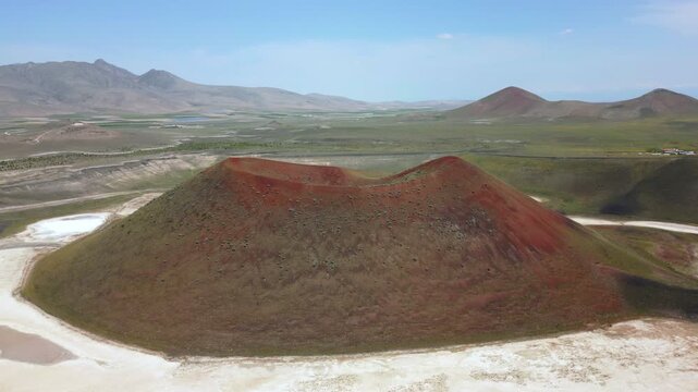 Drone aerial view of Lake Meke drying volcanic crater lake with red landscape in Turkey