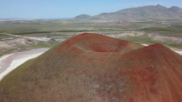 Drone aerial view of Lake Meke drying volcanic crater lake with red landscape in Turkey