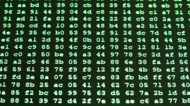 Hexadecimal computer code scrolling on green monitor screen
