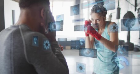 Boxing trainer holding pads while trainee moving and landing jabs, HUD panels stacking guiding aim