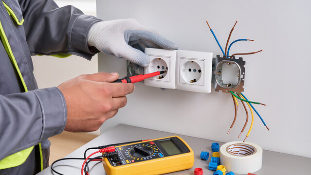 electrician repairing electrical outlet