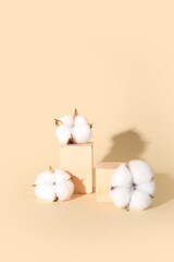 Cotton flowers and cubes on beige background