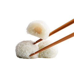 Chopsticks holding two white mochi desserts against a plain background