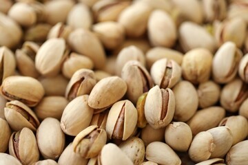 Tasty unpeeled pistachios as background, top view flat lay background
