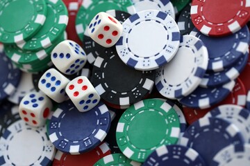 Dice game on the poker table in the casino. A successful combination of dice brought a lot of winning chips