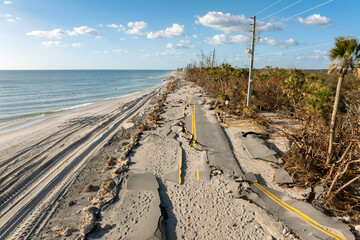 Road erosion after hurricane in Florida. Storm surge washed away asphalt on Manasota Key road at...