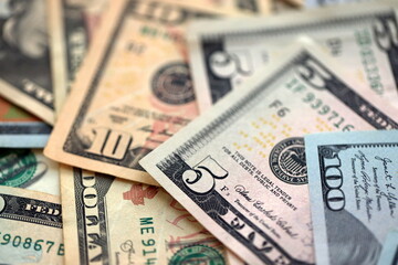 Big amount of different dollar bills close up. Hundred fifty twenty ten and five dollar banknotes