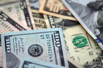 Big amount of different dollar bills close up. Hundred fifty twenty ten and five dollar banknotes