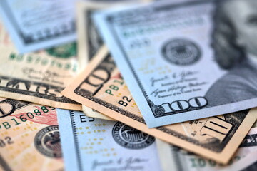 Big amount of different dollar bills close up. Hundred fifty twenty ten and five dollar banknotes