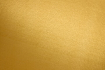 Gold foil background with diagonal light reflection